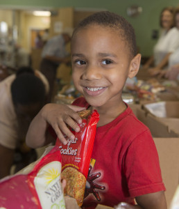 Child receiving food from a Florida homeless coalition
